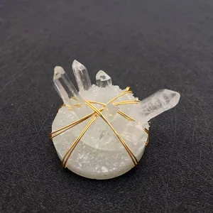 Top view of natural clear quartz cluster pendant with decorative gold wire wrapping