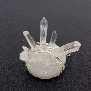 Detail of natural white crystal wire-wrapped pendant with silver wire on black background