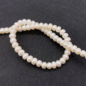 Macro shot of white AA grade freshwater button pearls showing natural luster and texture