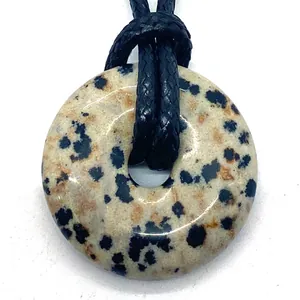 Polished 20mm Dalmatian Jasper donut pendant with a black adjustable woven cord