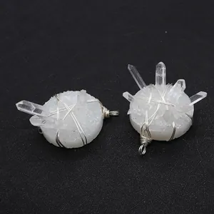 Macro view of handmade white druzy quartz crystal pendants with silver wire wrap detail