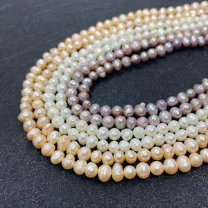 Macro detail of natural freshwater baroque pearls in white, gold, and purple tones