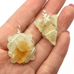 Handmade wire wrapped raw yellow crystal stone pendants in teardrop and geometric shapes
