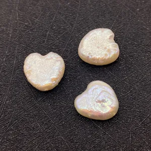 Macro shot of heart-shaped baroque pearls with rainbow luster for DIY jewelry making