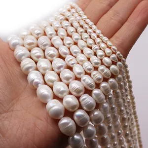 Detailed view of natural freshwater rice pearls in various sizes held by hand for scale