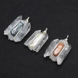 Macro shot of three baroque pearl and crystal wire-wrapped pendants on a black background