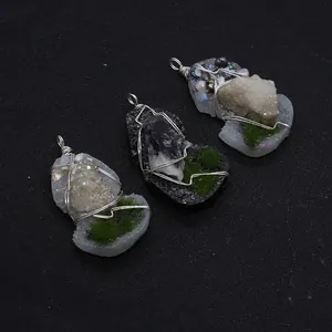 Macro shot of handmade wire-wrapped natural crystal pendants with pearl accents