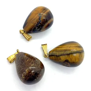 Three teardrop tiger eye stone pendants with golden clasps on a white background