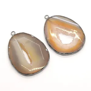 Pair of natural druzy agate teardrop pendants with metal edges and amber crystal texture