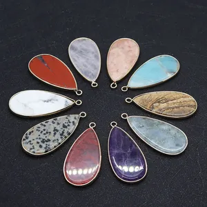 Macro detail of teardrop natural stone pendants with gold metal edge for DIY jewelry