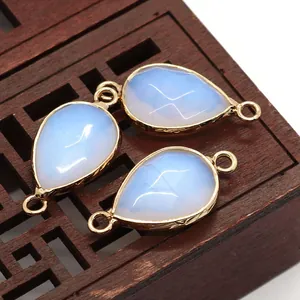 Detailed macro view of faceted teardrop natural stone pendants with gold metal frames