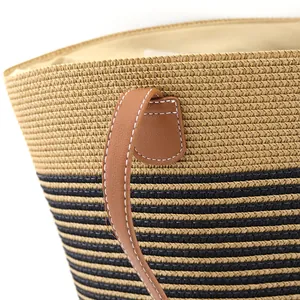 Bohemian striped straw tote bag with brown leather handles and woven texture details
