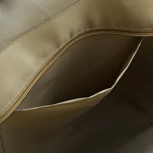 Detail of bohemian tote bag interior featuring champagne fabric lining and zipper pocket