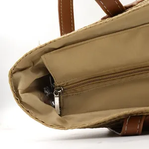 Detail view of woven tote interior with khaki fabric lining and metal zipper pocket