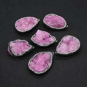 Macro shot of 6 pink druzy quartz pendants with sparkling crystals and rhinestone edges