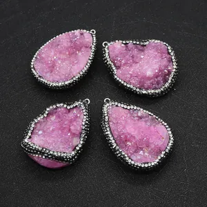 Close-up of four unique pink druzy quartz pendants with sparkling rhinestone edging details