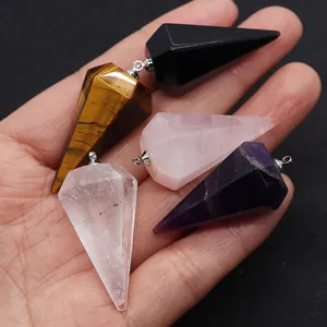 Macro detail of various polished natural stones in hexagonal cone shape with silver loop