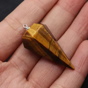 Macro detail of hexagonal tiger eye stone pendant with polished brown stripes and silver ring