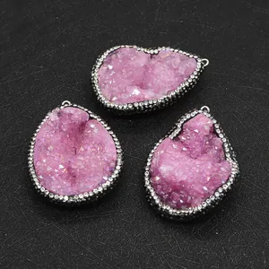 Macro detail of irregular pink druzy quartz pendants with sparkling rhinestone edges