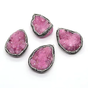 Pink druzy teardrop pendants with double-row rhinestones on white background