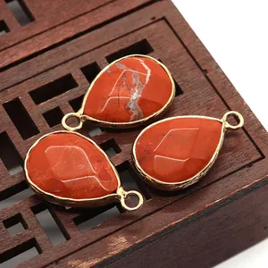 Macro detail of three faceted Red Jasper teardrop pendants with gold plated edging