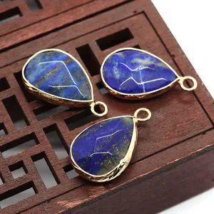 Detailed close-up of three teardrop-shaped Lapis Lazuli pendants with gold-plated edging
