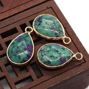 Macro view of teardrop natural stone pendants with gold plating for jewelry making
