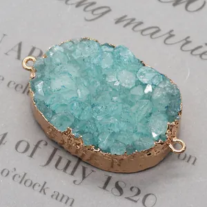 Detailed macro view of an oval blue druzy stone pendant with double golden connectors