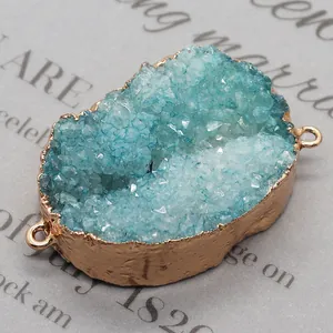 Macro shot of oval blue druzy crystal connector with gold plated edges for DIY jewelry
