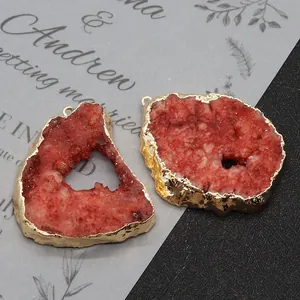 Detail of red druzy agate pendants with gold metal edges for DIY jewelry making