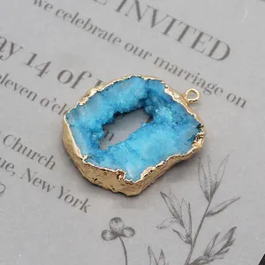 Macro detail of natural blue crystal stone pendant with golden plated edge on paper card