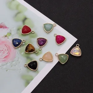 Detailed macro shot of faceted triangle stone pendants with gold plating for jewelry making