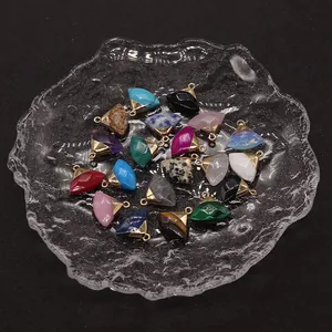 Macro shot of assorted fan-shaped natural stone pendants with gold-plated metal loops