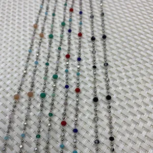 Macro shot of silver metal chains with colorful natural stone beads for DIY jewelry
