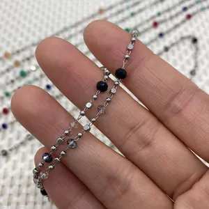Macro shot of silver metal bead chain with faceted natural stone and crystal accents