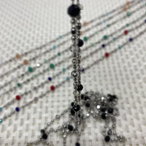 Close-up of colorful faceted crystal beads and silver metal spacer beads on a 10m roll chain