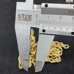 Measuring the 7mm width of a golden copper twisted chain link using a digital caliper