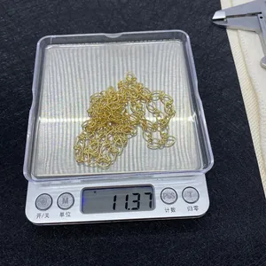 Detail view of 10m gold twisted oval link chain on scale weighing 11.37g for DIY jewelry
