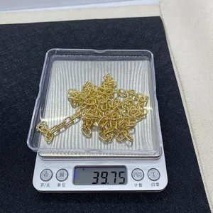 Golden 6x10mm oval twist chain being weighed on a digital scale showing 39.75g mass