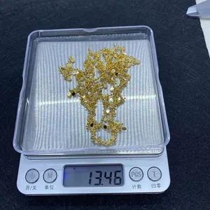 Detailed view of gold plated twisted chain with round sequins on a scale showing 13.46g weight