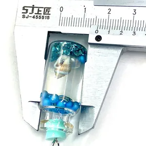 Détail mesurant 16mm du pendentif bouteille en verre avec coquillages et perles