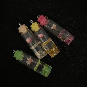 Mini glass bottle pendants with dried flowers and sequins for DIY jewelry making
