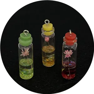 Three colorful 11x41mm glass bottle pendants with dried flowers and liquid for DIY jewelry