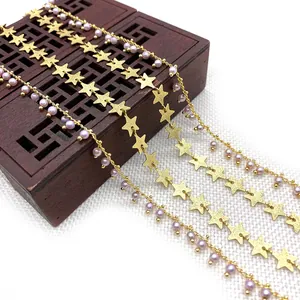 Golden star charms and lavender pearl chains displayed on a wooden jewelry box for DIY crafts