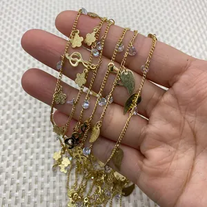 Gold twist chain necklace with musical note and flower charms with cubic zirconia