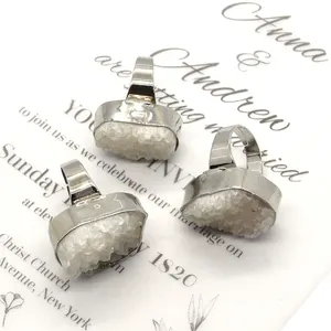 Three irregular natural white druzy quartz rings with silver edges on wedding invite