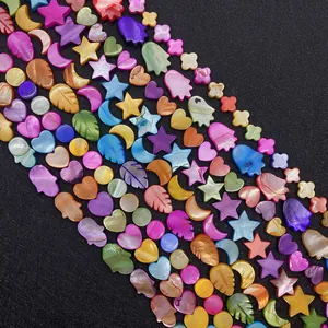 Macro shot of colorful mother of pearl beads in star, moon, and flower shapes for DIY