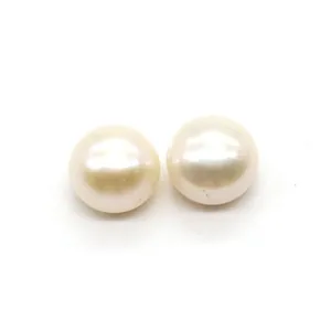 Detail view of two round white freshwater pearls with radiant luster for DIY jewelry making