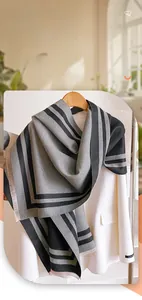 Close-up of grey striped cashmere-like scarf texture with delicate fringe edge