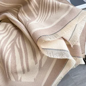 Elegant beige cashmere-feel winter scarf with soft wave pattern and delicate tassels
